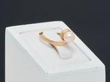 an image of a gold ring with a pearl on top of a white box