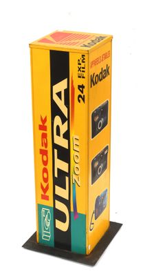 a yellow box with a camera on top of it