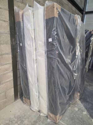 many pieces of furniture wrapped in plastic on the ground
