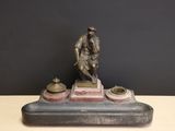 bronze statue of a man with a dog on a marble base