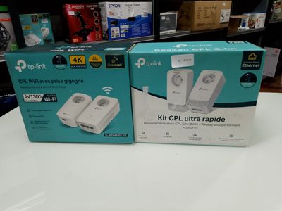 two boxes of wii game controllers sitting on a table in a store