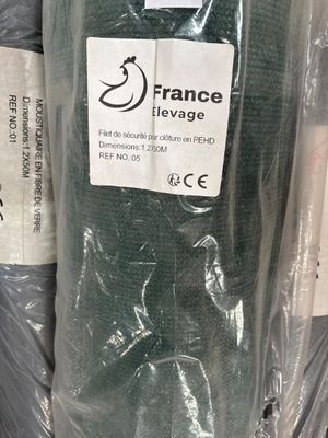 many rolls of fabric wrapped in plastic bags on a shelf