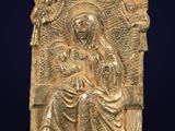 an image of a gold statue of a woman and two birds