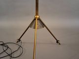 a lamp that is sitting on a tripod stand