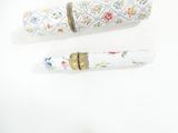 two pens sitting next to each other on a white surface
