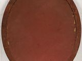 an image of a brown plate on a white wall with a white wall in the background