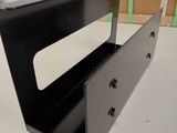 a picture of a black metal shelf on a white table