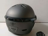 a helmet that is sitting on a table next to a pair of ear buds