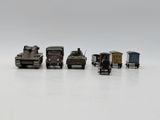 several toy trucks are lined up in a row on a white surface