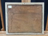 an old picture frame sitting on top of a wooden table