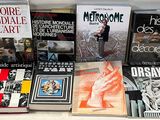 several books on a white table with a white background