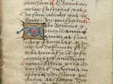 un vieux livre sur lequel figurent une croix et une fleur