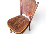 an image of a wooden chair with a carved seat on a white background