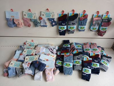 many pairs of socks hanging on the wall next to each other