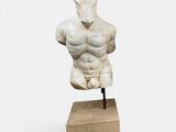 sculpture of a male torso on a wooden base
