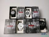 several watches are in a box on a white surface