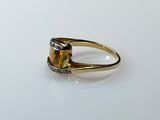 a gold ring with a citrine and diamonds on it