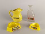 a yellow pitcher and a yellow ashtray and a glass bottle