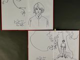 drawings of a man and a woman are hanging on a wall