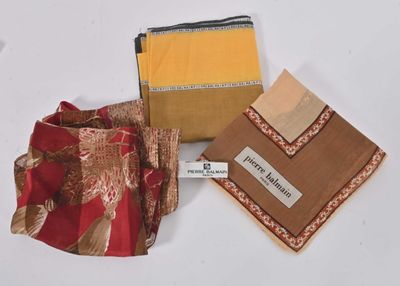 three pieces of cloth are sitting on top of a white surface