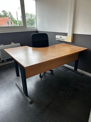a desk with a chair and a window in the room