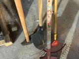 two shovels and a rake on the ground