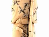 figurine of a woman in a kimono robe holding a bamboo stick
