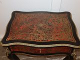 a small table with a red and black design on it