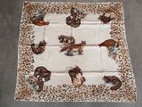 a close up of a table cloth with animals on it