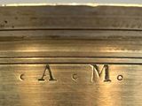 a close up of a brass plate with the word a m on it