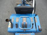 a blue machine that is sitting on the street
