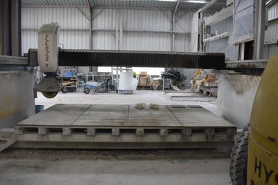 a machine that is cutting a piece of wood in a building