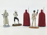 star wars figurines are lined up in a row on a white surface