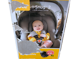 a baby sitting in a car seat in a box