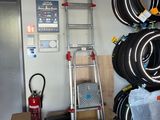 a ladder that is next to a pile of tires
