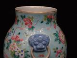 a vase with a lion head on it on a black background