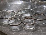 a table with a bunch of glasses and a bottle on it
