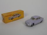 a small toy car next to a box of toys