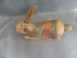 a small wooden animal that is sitting on a table