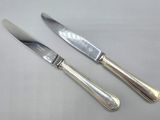 two knives and a knife on a table