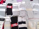 many pairs of socks that are sitting on a table