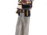 figurine of a man playing a bagpipe on a wooden base