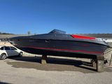 a boat that is sitting on a trailer in the parking lot