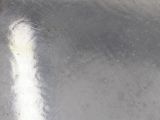 a close up of a silver plate with a spoon in it