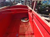 a red truck that has a basket in the back of it