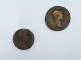 two coins of the same type are shown on a white surface