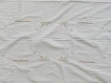 a white table cloth with a butterfly design on it