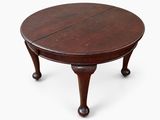 a round mahogany table with turned legs and turned top
