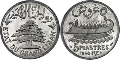 a close up of a silver coin with a tree on it