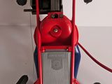 a red and blue toy car with wheels and a hose attached to it